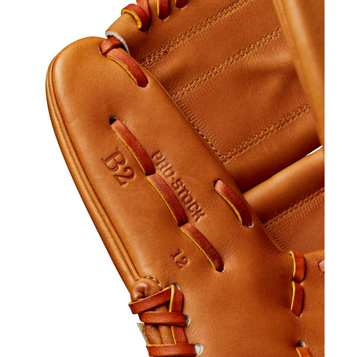 Close-up of the Wilson A2000 B2 12" Baseball Glove (WBW10208212) made from Pro Stock leather, featuring detailed stitching, embossed “B2,” “PRO STOCK,” and “12” text, plus bold red and yellow laces.