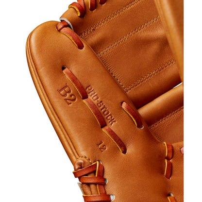 Close-up of the Wilson A2000 B2 12" Baseball Glove (WBW10208212) made from Pro Stock leather, featuring detailed stitching, embossed “B2,” “PRO STOCK,” and “12” text, plus bold red and yellow laces.