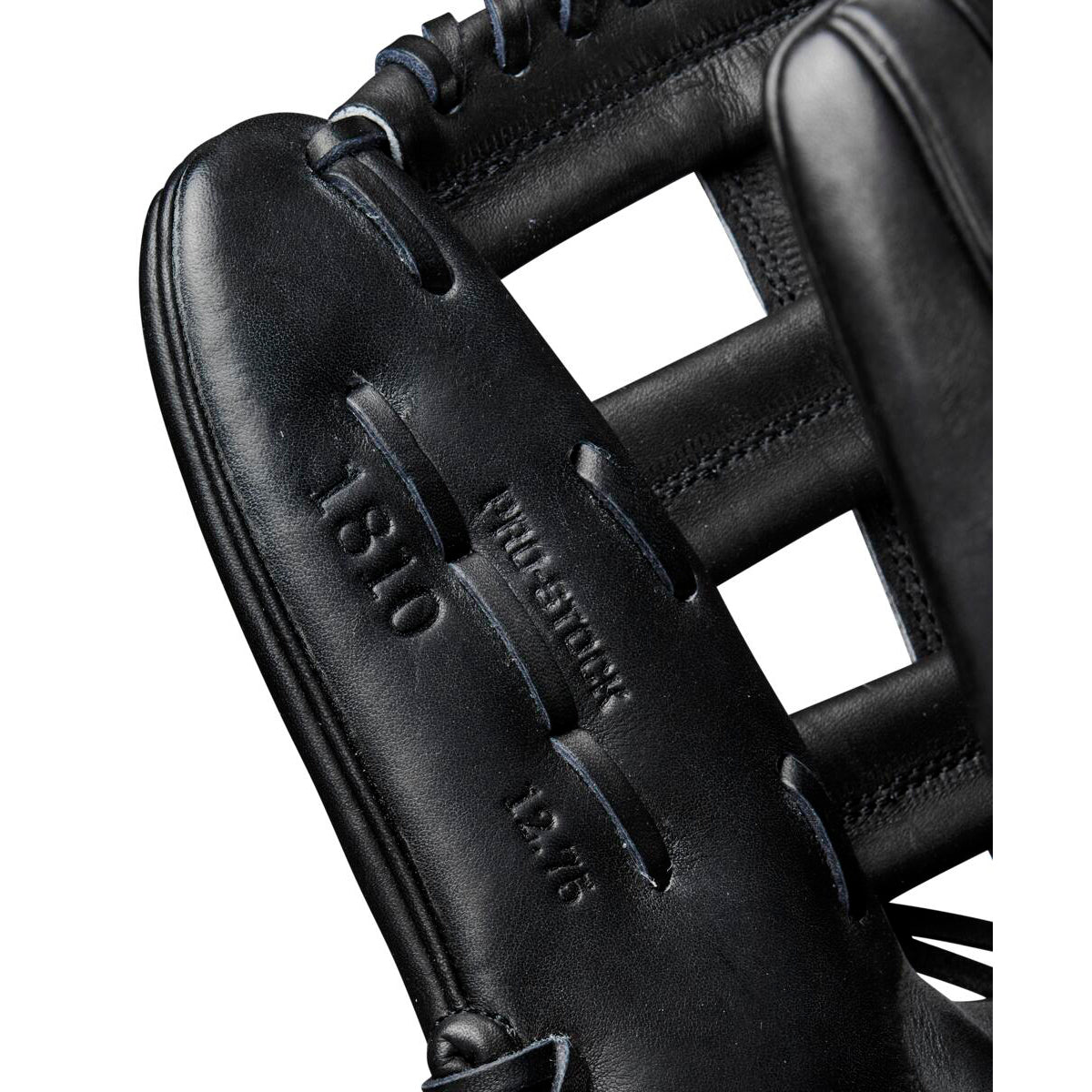 Close-up of a black Wilson A2000 1810 12.75" baseball glove showing detailed stitching and embossed Wilson branding. The glove’s webbing and part of the fingers are also visible.