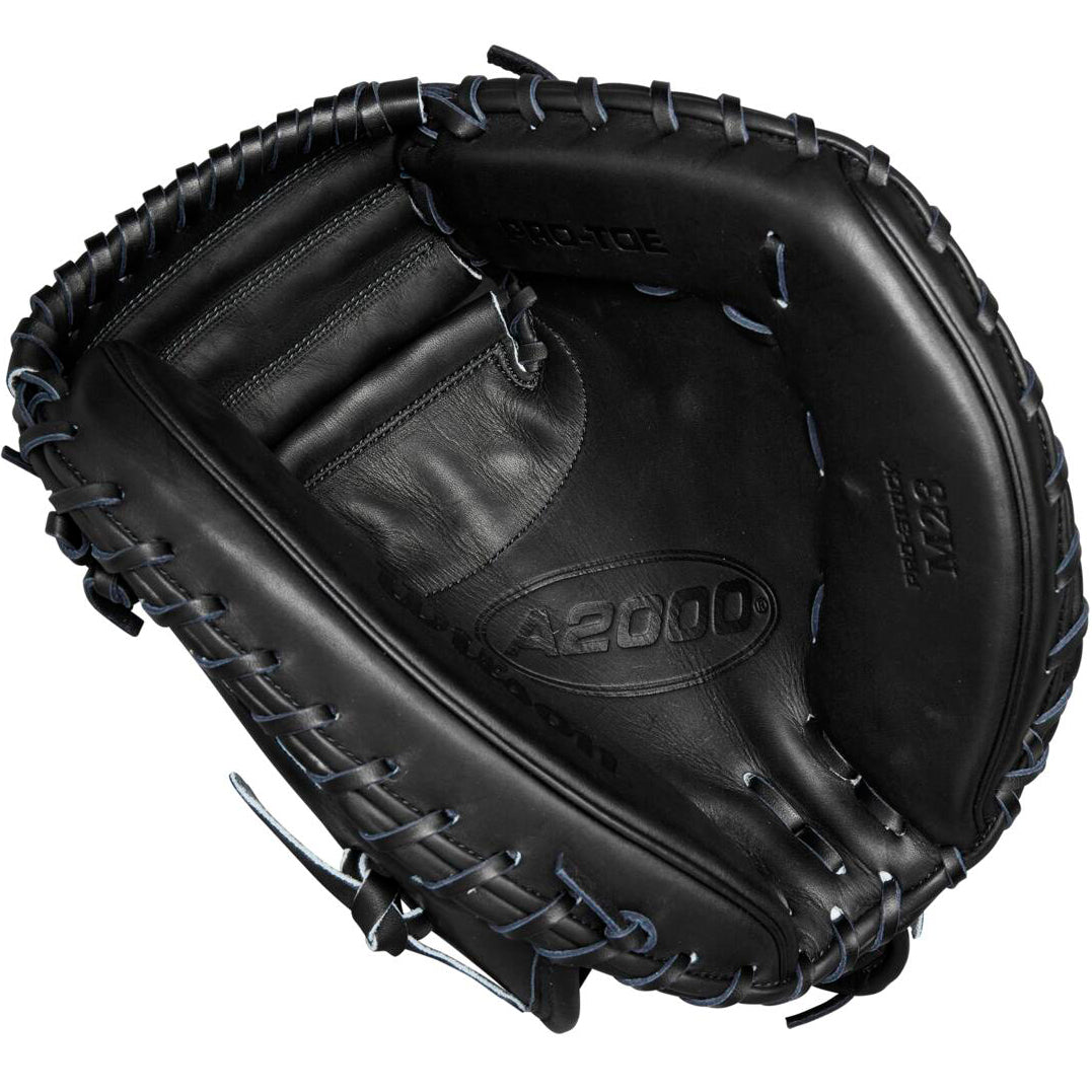 A Wilson A2000 M23 33.5" Baseball Catcher's Mitt (WBW102092335) is shown from above, highlighting its black Pro Stock leather, visible stitching, embossed Wilson branding, deep pocket, and webbing details.