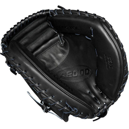 A Wilson A2000 M23 33.5" Baseball Catcher's Mitt (WBW102092335) is shown from above, highlighting its black Pro Stock leather, visible stitching, embossed Wilson branding, deep pocket, and webbing details.