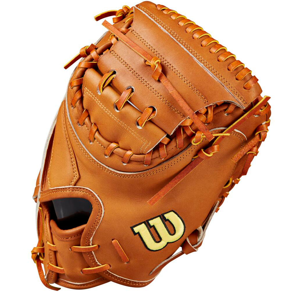 The Wilson A2000 M23 33.5" Baseball Catcher's Mitt (WBW102094335) features tan Pro Stock leather, brown laces, and a yellow W logo, shown angled to highlight its clean stitching and webbing.