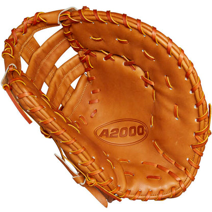 A Wilson A2000 1679 12.5" First Base Mitt (model WBW102099125), crafted in brown Pro Stock leather with yellow stitching, is displayed open to reveal its interior and webbing, with "A2000 1679" embossed in the palm.