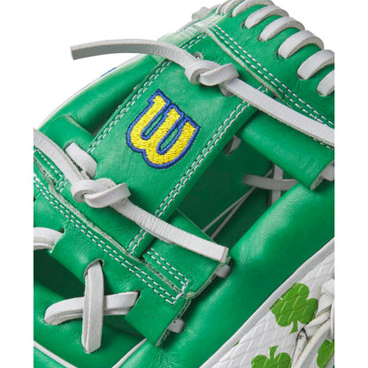 Close-up of a Wilson A2000 1786 11.5" MDA Shamrocks Baseball Glove (WBW102148115) featuring green Pro Stock leather, white laces and stitching, a yellow and blue W logo, and green shamrocks on a stylish white section.
