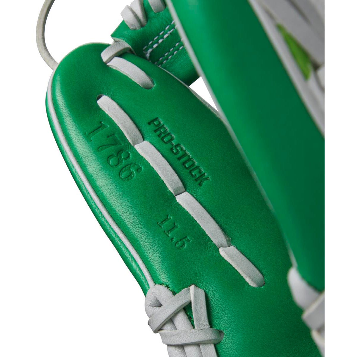 Close-up of the Wilson A2000 1786 11.5" MDA Shamrocks Baseball Glove (WBW102148115), featuring green Pro Stock leather, white laces, and embossed details—PRO STOCK, 1786, and 11.5"—inside this premium Wilson infield glove.