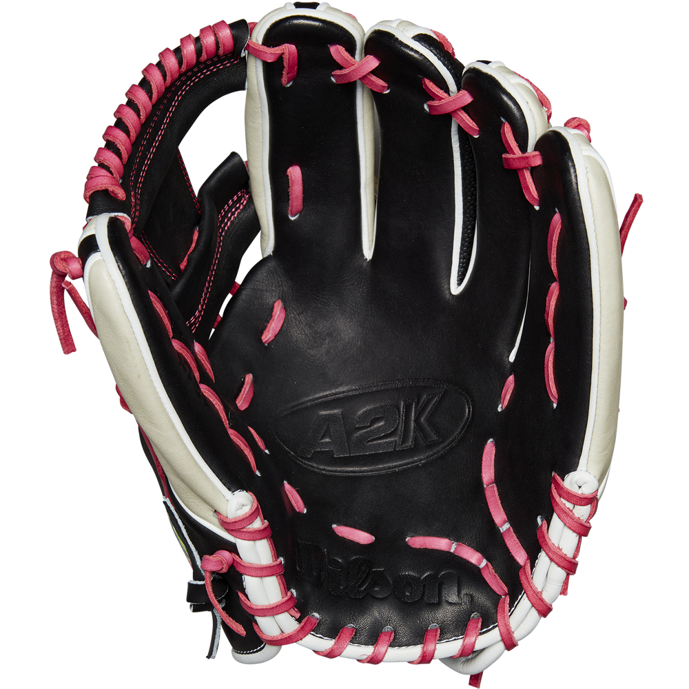 The Wilson A2K 1724 11.75" Baseball Glove (GOTM June 2024) by Wilson is shown open with black Pro Stock Select leather, white accents, and pink laces, displayed against a plain white background.