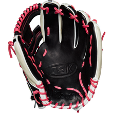 The Wilson A2K 1724 11.75" Baseball Glove (GOTM June 2024) by Wilson is shown open with black Pro Stock Select leather, white accents, and pink laces, displayed against a plain white background.