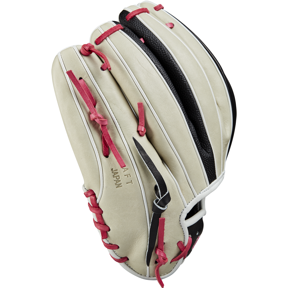 The Wilson A2K 1724 11.75" Baseball Glove (GOTM June 2024) in beige with red laces, black webbing, and white trim, made from Pro Stock Select leather, displays JAPAN and AFT embossed on the side against a plain white background.