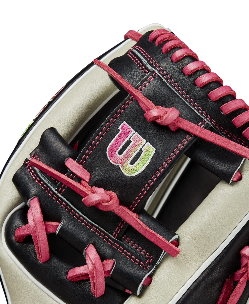 Close-up of the Wilson A2K 1724 11.75" Baseball Glove (GOTM June 2024, WBW1022571175) featuring black and cream Pro Stock Select leather, red stitching and laces, plus a green and white embroidered W logo on the back.