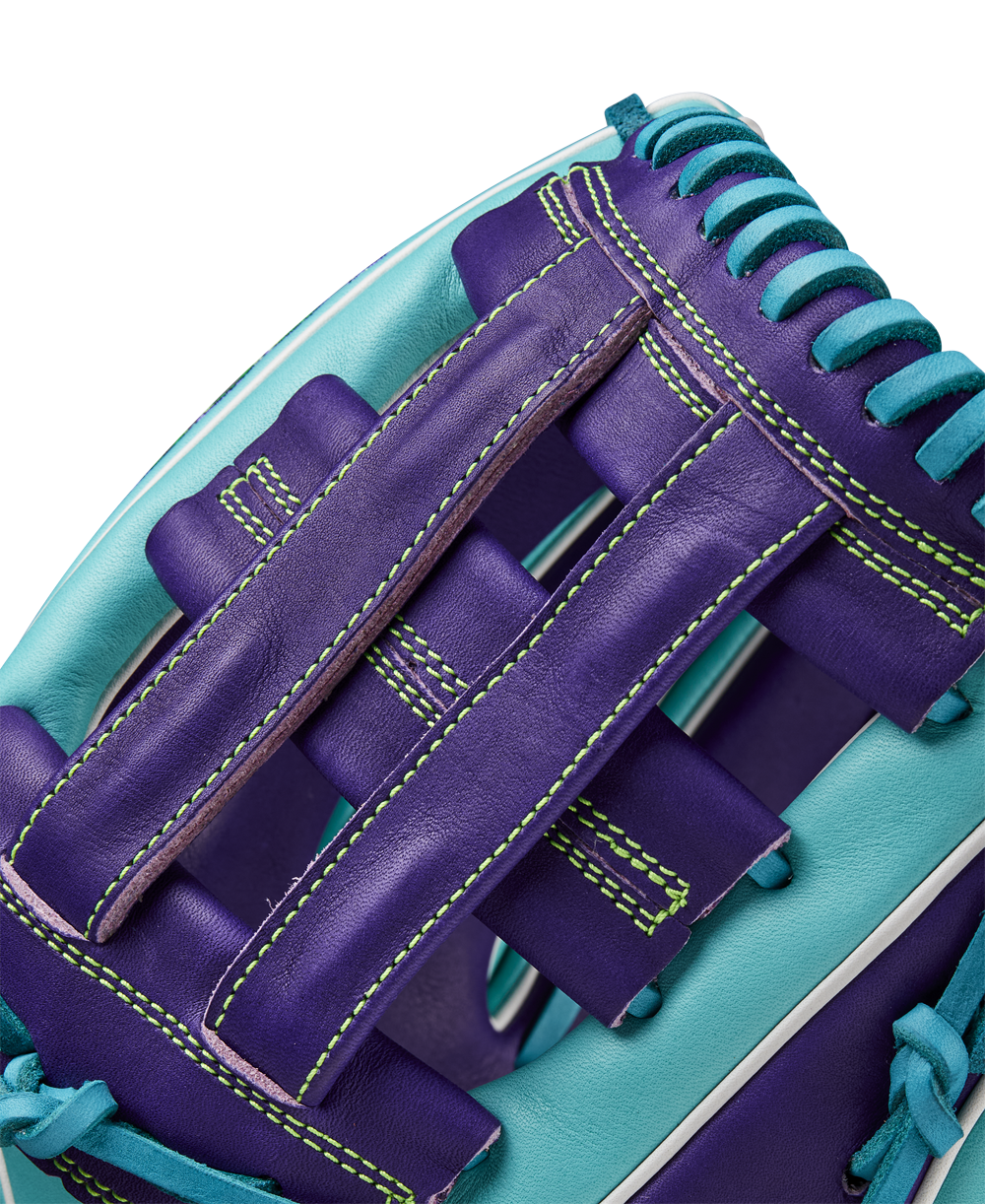 Close-up of the Wilson A2000 DW5 12" Baseball Glove (WBW10252212), showcasing purple Pro Stock leather with teal accents, teal stitching and laces, and a woven web—expertly crafted for Winter 2024.