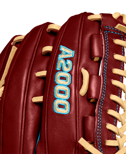 Close-up of a Wilson A2000 D33 11.75" baseball glove (Winter 2024), maroon Pro Stock leather with tan laces, blue stitching, and “A2000” embroidered in blue on the side.