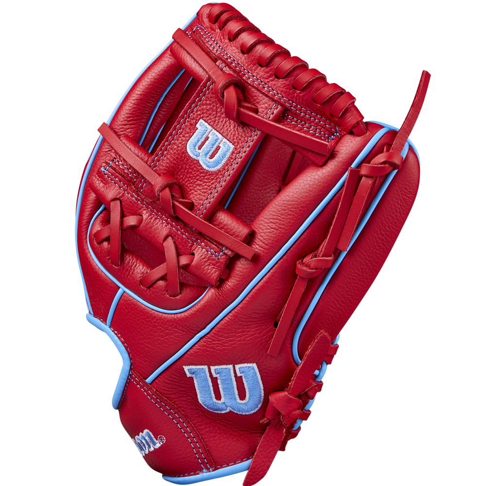 A Wilson A500 11.5" Baseball Glove (WBW102540115) in bright red with light blue accents and stitching, displaying the classic Wilson “W” logo in blue and white on the thumb and wrist, is shown upright against a plain background.