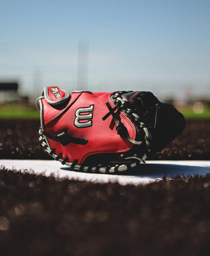 A Wilson A500 32" Baseball Catcher's Mitt (WBW10254632) is on the field, ready for game day.