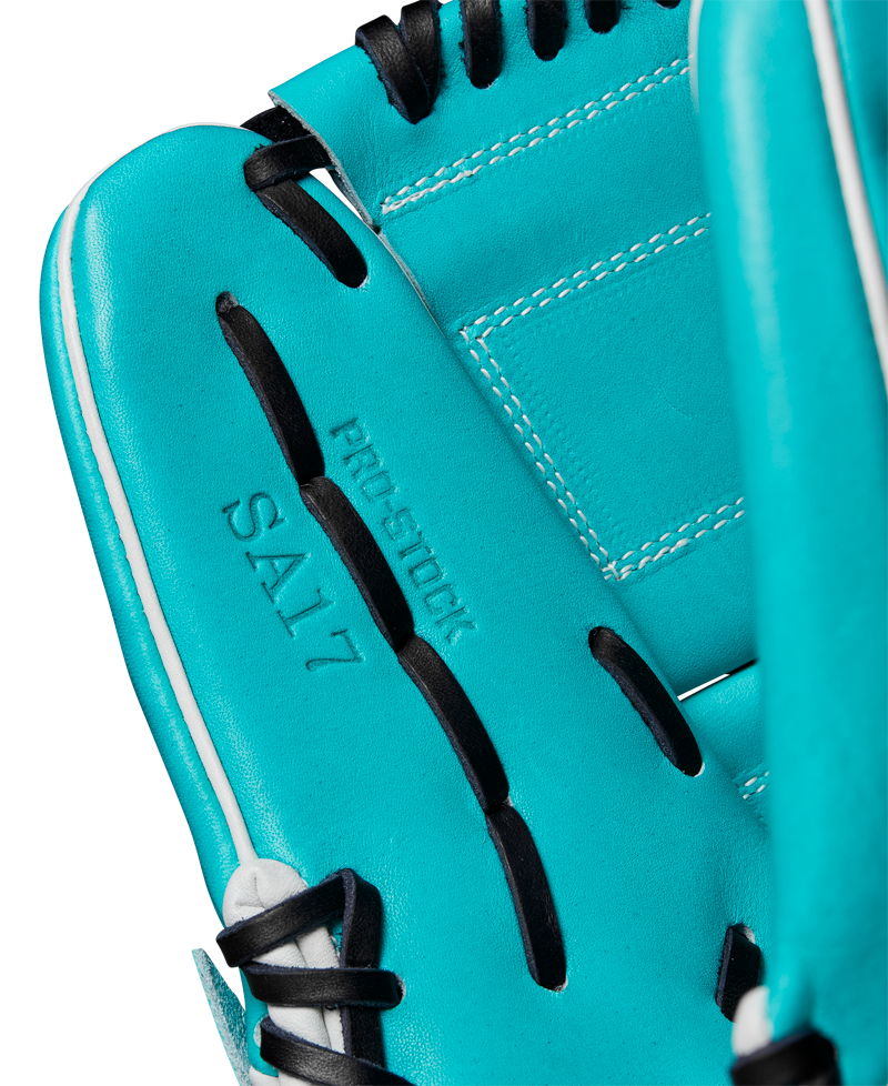 A close-up of the Wilson A2000 SA17 12" Baseball Glove features teal Pro Stock® leather, black laces, and white stitching. PRO STOCK and SA17 are embossed on the palm, showcasing Wilson’s quality craftsmanship. SPRING 2025: WBW10255012.