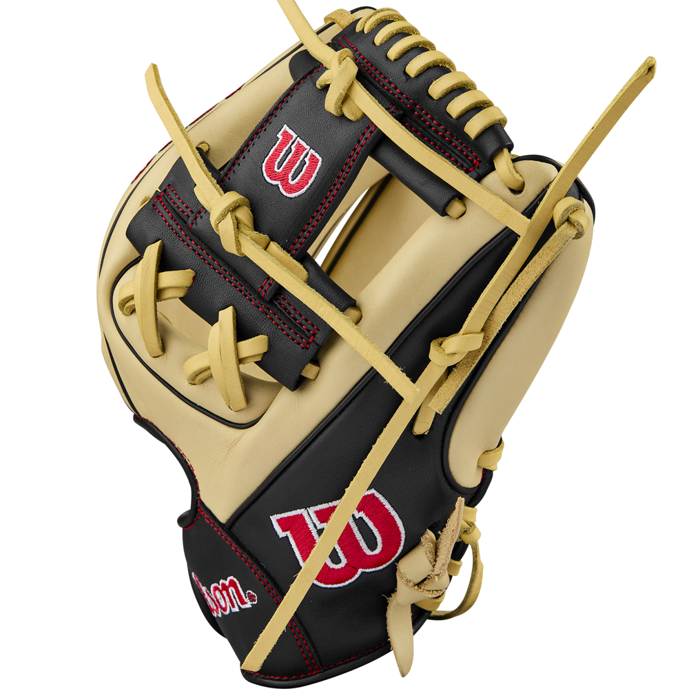 A Wilson A900 PF115 11.5" baseball glove in tan and black, featuring red stitching and a white Wilson logo on the thumb and wrist, is displayed against a plain white background.