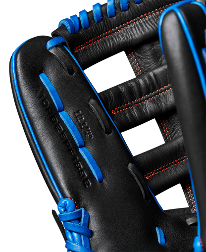 Close-up of the Wilson A1000 PF1892 12.25" baseball glove, featuring black full grain leather, blue laces, red stitching, open webbing, and "12.25" stamped on the leather. Model: WBW1025831225.
