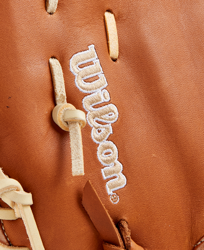 Close-up of a Wilson A1000 1620 12.5" first base mitt (WBW102587125), crafted from full grain leather with tan laces and white embroidered Wilson branding.