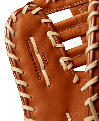 A close-up of the Wilson A1000 1620 12.5" Baseball First Base Mitt (WBW102587125) by Wilson, crafted from full grain leather with cream-colored laces and embossed model details on the palm.