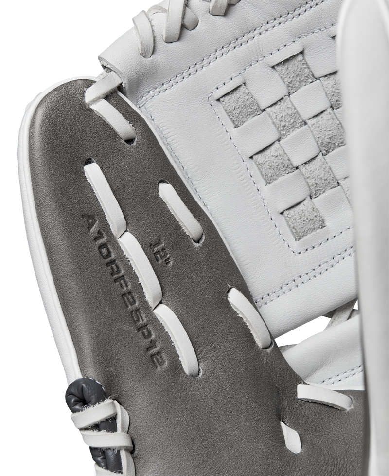 Close-up of a Wilson A1000 P12 12" Fastpitch Glove (WBW10259212) shows gray and white Full Grain leather, visible stitching, and a woven rectangular pattern with "A1000 P12 12”" embossed inside the glove.