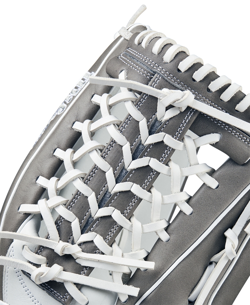 Close-up of the Wilson A1000 T125 12.5" Fastpitch Glove (WBW102596125) by Wilson, featuring detailed white lacing, grey full grain leather, and intricate stitching that highlights its textured outfield design.
