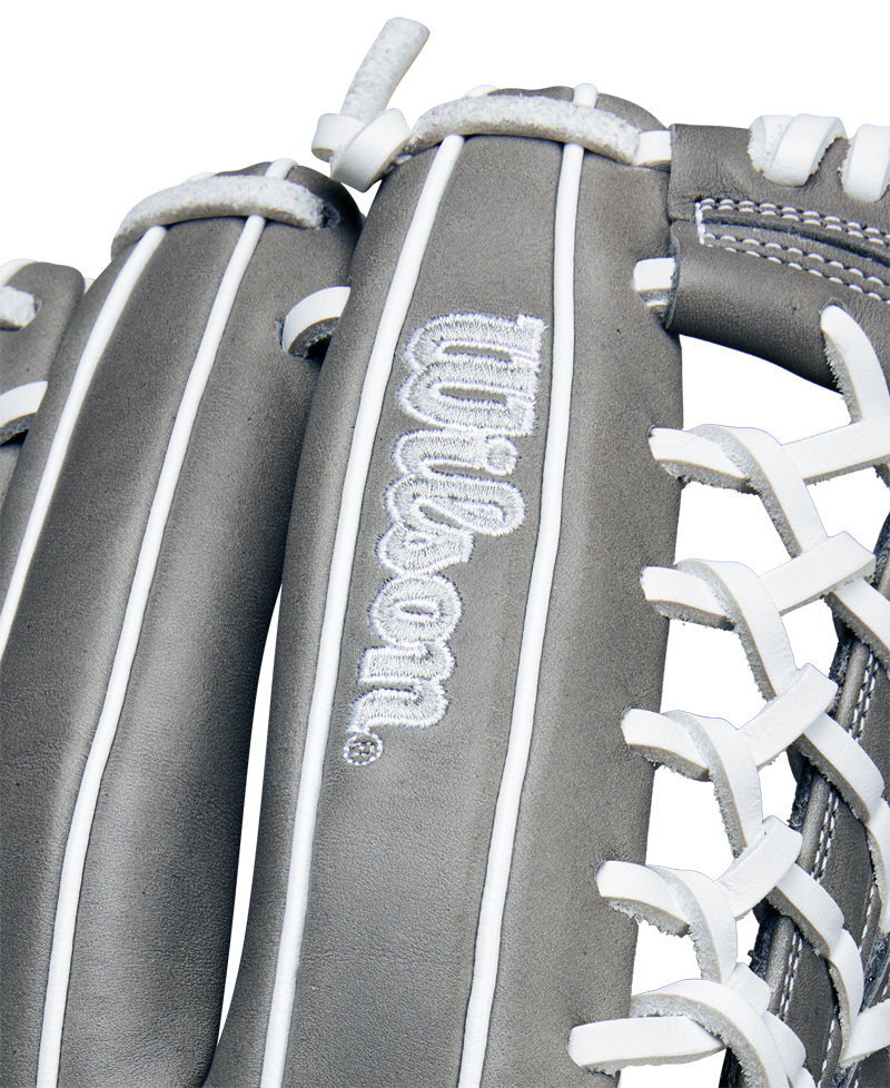 Close-up of the Wilson A1000 T125 12.5" Fastpitch Glove (WBW102596125) in gray, featuring white stitching and laces, full grain leather, and the embroidered Wilson logo on the leather surface.