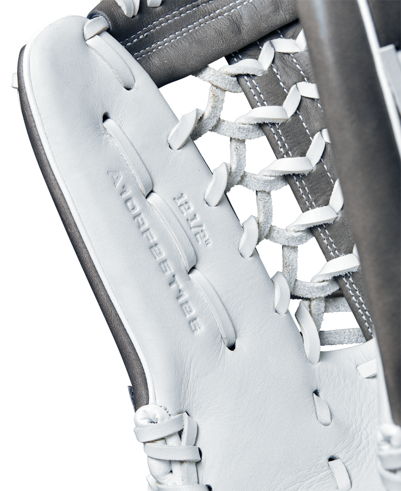 Close-up of the Wilson A1000 T125 12.5" Fastpitch Glove, crafted from full grain leather with detailed lacing and visible embossed text. The glove features white and gray colors, with stitching and leather details clearly shown.