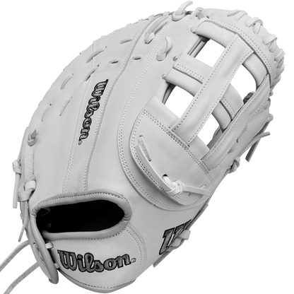 The Wilson A1000 1620 12.5" Fastpitch First Base Mitt (WBW102598125) is a white, full-grain leather mitt featuring visible stitching and laces, with the Wilson logo embroidered on the thumb and palm. Its webbing and pocket are clearly displayed.