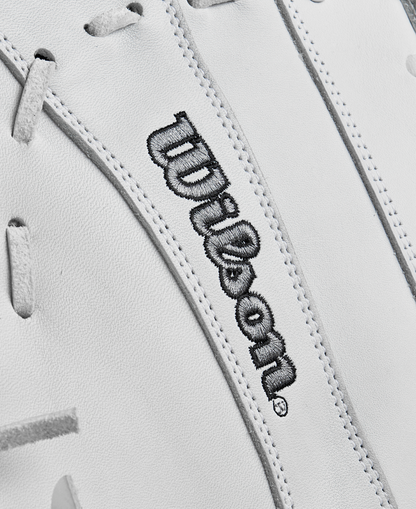 Close-up of the Wilson A1000 1620 12.5" Fastpitch First Base Mitt's white full-grain leather surface with gray laces and Wilson embroidered in black, highlighting its premium quality.