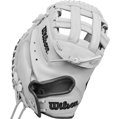 The Wilson A1000 CM33 33" Fastpitch Catcher's Mitt (WBW10260033) features a white design with black stitching, Wilson branding, open web, visible leather lacing, and is made from durable full grain leather.