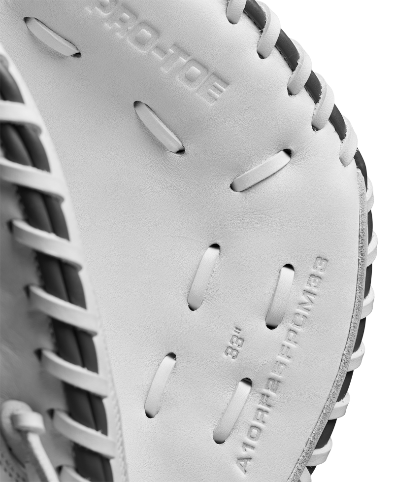 Close-up of the Wilson A1000 CM33 33" Fastpitch Catcher's Mitt by Wilson, made from full grain leather with detailed stitching, black laces, and embossed interior text.