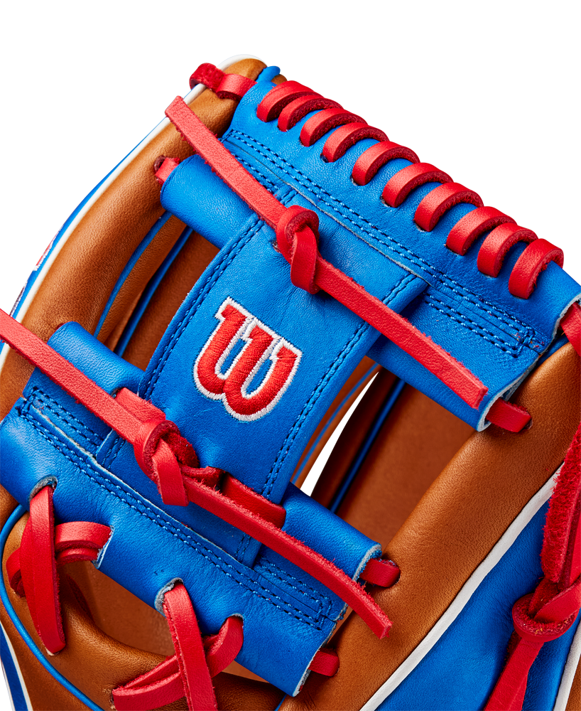 Close-up of the Wilson A2K 1786 11.5" Mookie Betts GM Baseball Glove (FALL 2024), made with Pro Stock Select leather in brown and blue, red laces and stitching, and featuring a white W logo outlined in red on the blue surface.