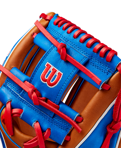 Close-up of the Wilson A2K 1786 11.5" Mookie Betts GM Baseball Glove (FALL 2024), made with Pro Stock Select leather in brown and blue, red laces and stitching, and featuring a white W logo outlined in red on the blue surface.
