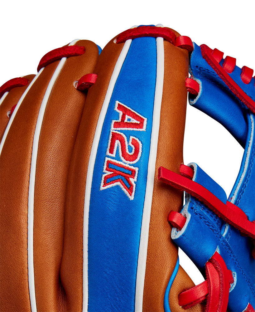 Close-up of the Wilson A2K 1786 11.5" Mookie Betts GM Baseball Glove, featuring select brown leather with blue and red accents, and "A2K" stitched in red and white on a blue panel. Brand: Wilson. Model: WBW102616115 (FALL 2024).
