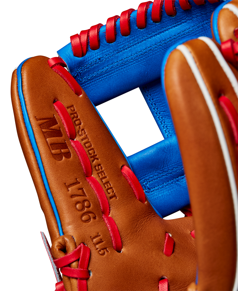 Close-up of the Wilson A2K 1786 11.5" Mookie Betts GM Baseball Glove, crafted from Pro Stock Select leather in brown with red lacing and blue accents. Features "PRO STOCK SELECT 1786 11.5" and MB initials. Model: WBW102616115 (Fall 2024).