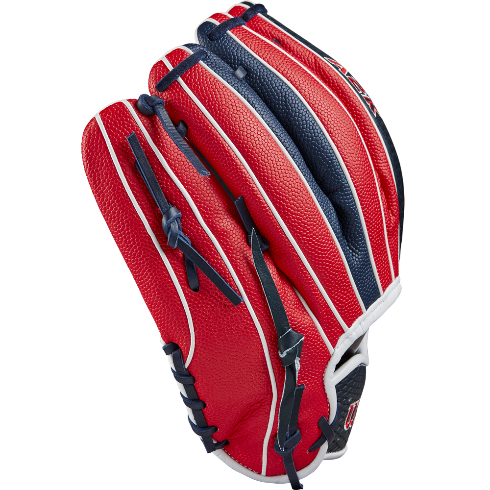 The Wilson A2K 1724SS 11.75" Baseball Glove (FALL 2024) features a red, white, and blue design with Pro Stock Select leather, black laces, and white accent stripes, displayed closed on a light gray background.