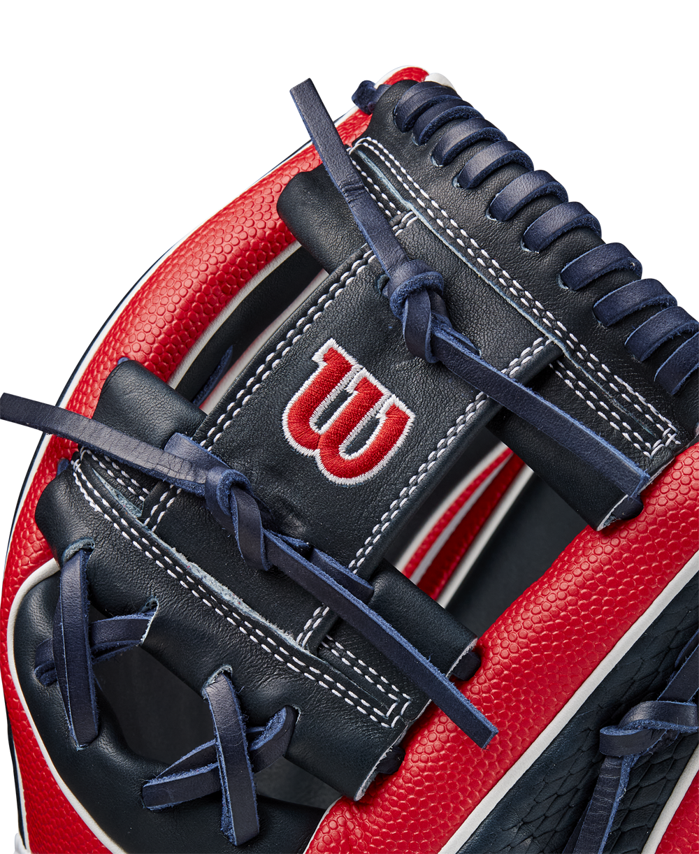 Close-up of the Wilson A2K 1724SS 11.75" Baseball Glove (FALL 2024), showing Pro Stock Select leather, detailed stitching, laces, SuperSkin accents, and the iconic white W logo on the red and navy blue design.