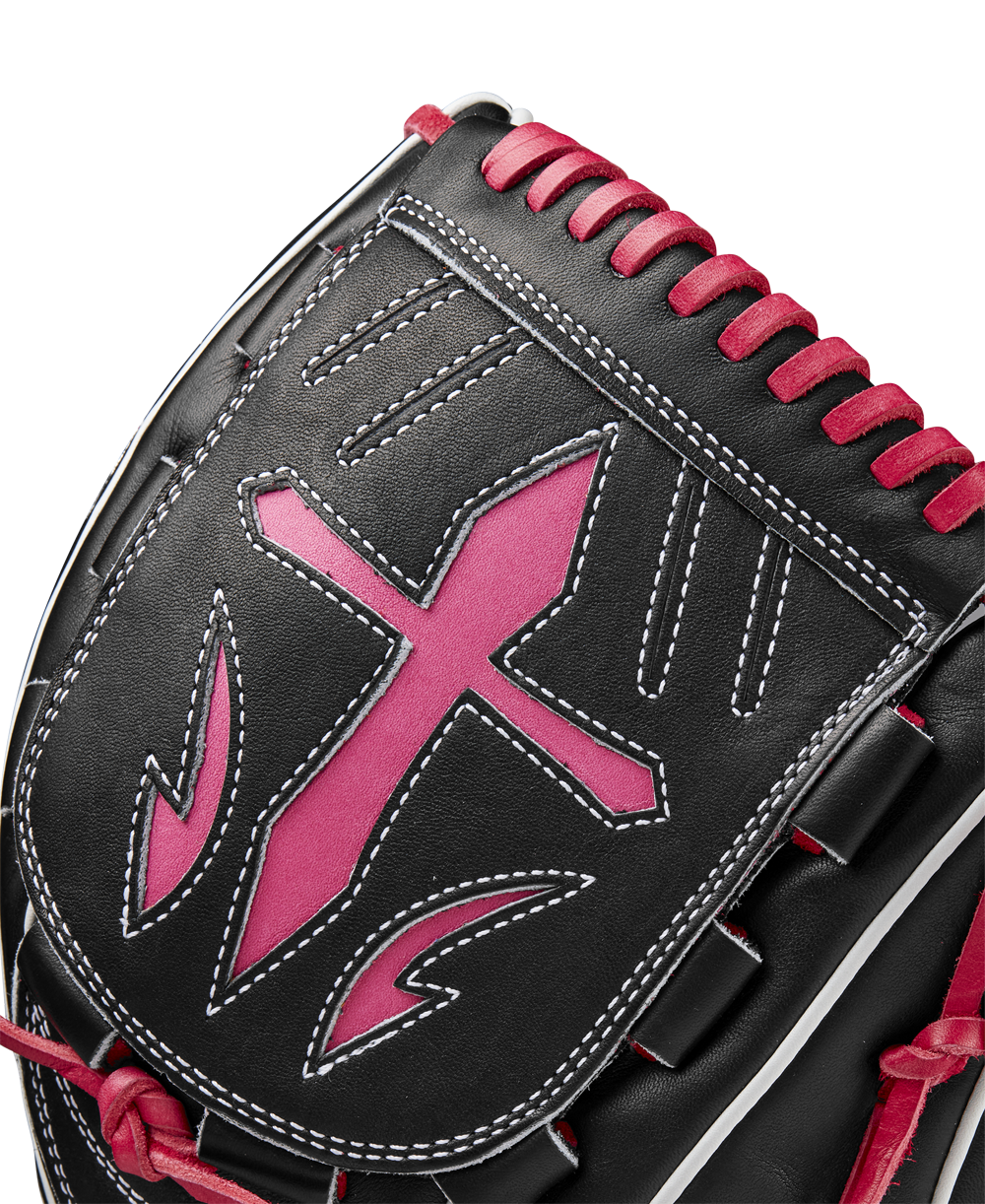 Close-up of the Wilson A2K B23 12" Baseball Glove (FALL 2024), featuring Pro Stock leather in black with white stitching, a bold pink-edged cross design, and pink lacing along the top.