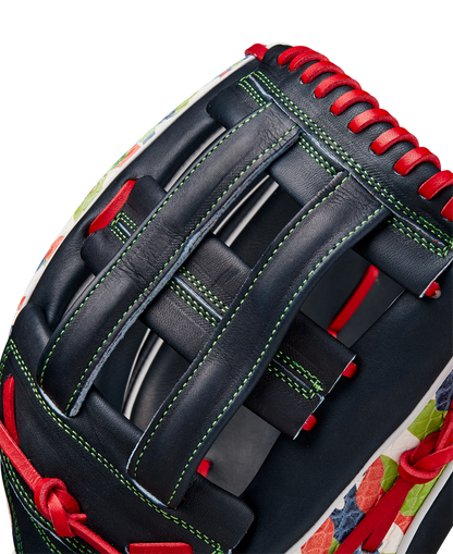 Close-up of the Wilson A2K MH23 12.75" Michael Harris GM Baseball Glove (WBW1026201275), crafted from Pro Stock Select leather in navy blue with red laces, green stitching, a floral pattern on the edge, and a woven web.