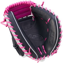 The Wilson A2K M23 33.5" Catcher's Mitt (WBW102622335) features black Pro Stock Select leather with pink laces and lining, plus PRO-TOE and A2K embossed inside.