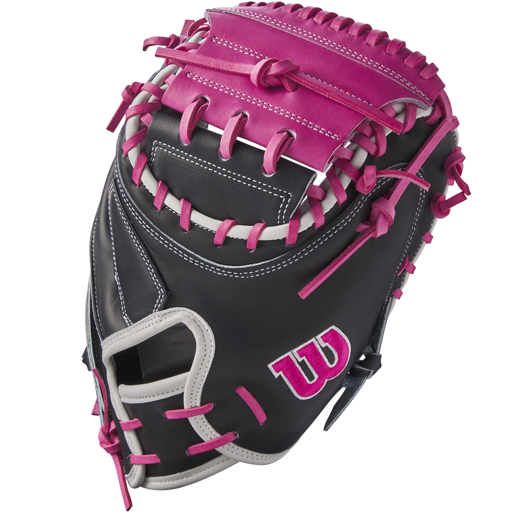 The Wilson A2K M23 33.5" Baseball Catcher's Mitt (FALL 2024: WBW102622335) features a black Pro Stock Select leather shell, pink and gray lacing, a pink W logo on the side, and contrasting pink and gray stitching throughout.