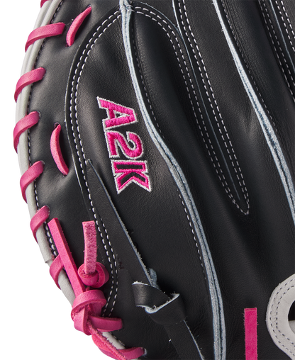 Close-up of a Wilson A2K M23 33.5" Catcher's Mitt (FALL 2024, WBW102622335) in black Pro Stock Select leather with pink lacing and stitching, plus embroidered pink A2K text on the glove's surface.