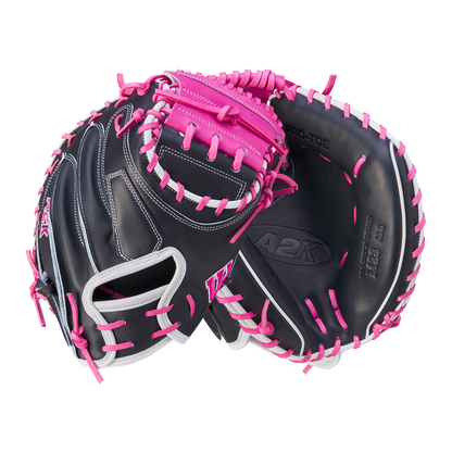 The Wilson A2K M23 33.5" Catcher's Mitt (WBW102622335) features black Pro Stock Select leather with white, pink, and magenta lacing, shown palm and back view on white. Marked with A2K and Pro-I Web. Brand: Wilson. FALL 2024 release.