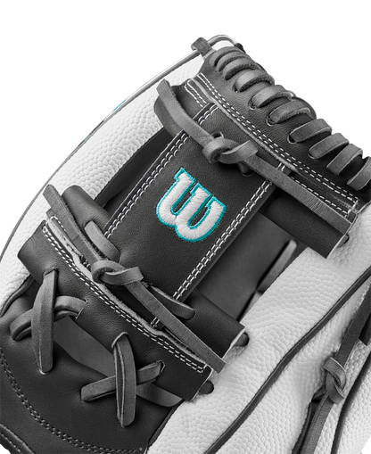 Close-up of the Wilson A2000 H75SS 11.75" Fastpitch Glove, showcasing black and white SuperSkin material, detailed stitching, laces, and a blue embroidered W logo on the leather.