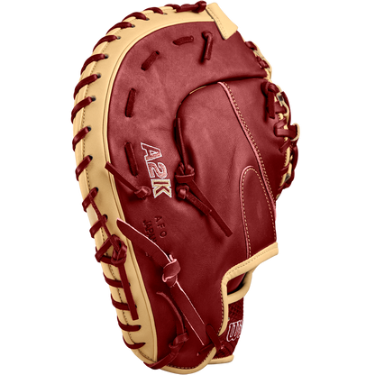 The Wilson A2K 1679 12.5" First Base Mitt (FALL 2024: WBW102684125), in red and tan Pro Stock Select leather with stitched A2K logos, is shown on a plain white background.