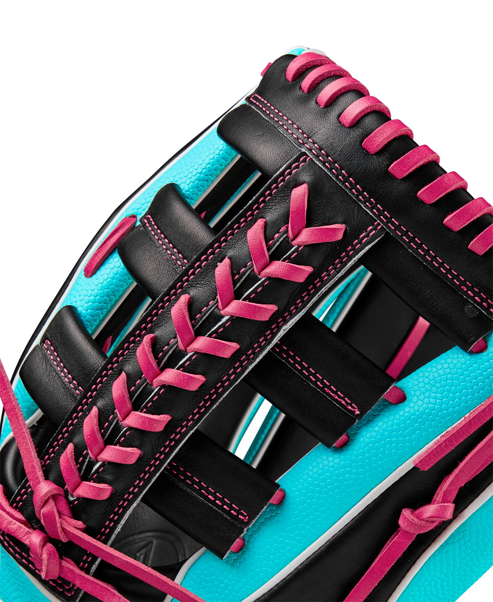 Close-up of the Wilson A2K 1810SS 12.75" Baseball Glove (Winter 2024: WBW1026881275) showing bright turquoise Pro Stock Select leather, black panels, and vivid pink laces accentuating the glove’s texture and stitching.