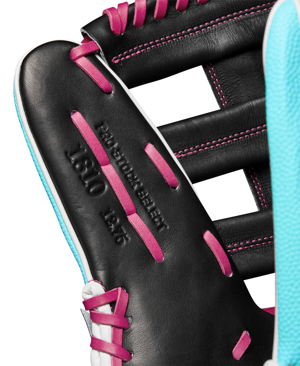 Close-up of a black Wilson A2K 1810SS 12.75" baseball glove with pink laces, light blue trim, and "PRO STOCK SELECT 1810 12.5" embossed on the leather. Model: WBW1026881275, Winter 2024 collection.