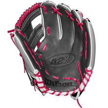 The Wilson A2K 1786SS 11.5" Baseball Glove - SPRING 2025 (WBW102690115) features a black design with white accents, bright pink laces, and durable SuperSkin and Pro Stock Select leather, shown palm up on a white background.