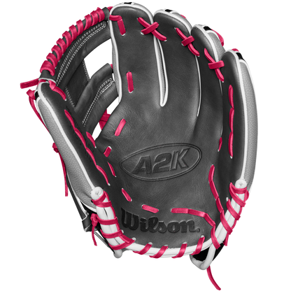 The Wilson A2K 1786SS 11.5" Baseball Glove - SPRING 2025 (WBW102690115) features a black design with white accents, bright pink laces, and durable SuperSkin and Pro Stock Select leather, shown palm up on a white background.