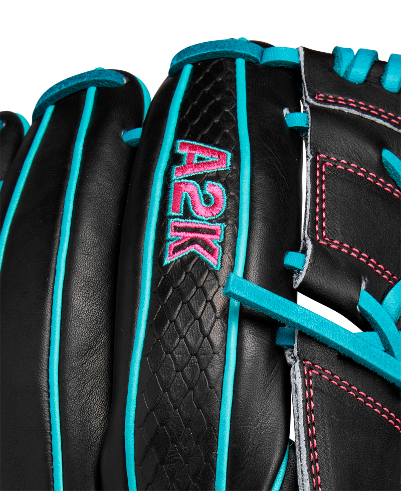 Close-up of the Wilson A2K B2 12" Baseball Glove (SPRING 2025): black Pro Stock Select leather with teal laces and trim, pink stitching, Closed 2-Piece Web, and “A2K” embroidered in teal and pink.