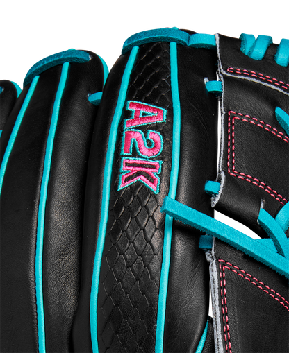Close-up of the Wilson A2K B2 12" Baseball Glove (SPRING 2025): black Pro Stock Select leather with teal laces and trim, pink stitching, Closed 2-Piece Web, and “A2K” embroidered in teal and pink.
